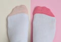 Female feet in socks on a pastel background. Copy space. Top view.