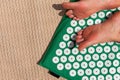 Female feet standing on acupressure mat. Self acupuncture massage