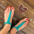 Female feet wearing turquoise sandals. Royalty Free Stock Photo