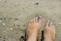 Female feet in wet beach sand Royalty Free Stock Photo