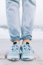 Female feet in wet sneakers and jeans Royalty Free Stock Photo