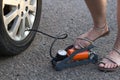 Female feets in sandals on the side of the road Royalty Free Stock Photo