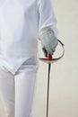 Female fencer hold the epee isolated on white background