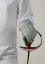 Female fencer hold the epee isolated on white background