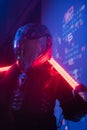 Woman in Futuristic Tactical Black Suit and Motorcycle Helmet with Neon Lamps