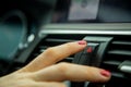 A female finger press the emergency light button on the dashboard of a car. close-up, soft focus, in the background car Royalty Free Stock Photo