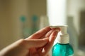 A female finger presses on a disinfectant gel in a small plastic Royalty Free Stock Photo