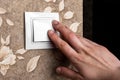 Female finger is turn on or off on light switch on wall Royalty Free Stock Photo