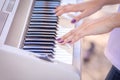 Female fingers on the keys of a musical instrument synthesizer Royalty Free Stock Photo