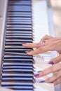 Female fingers on the keys of a musical instrument synthesizer Royalty Free Stock Photo