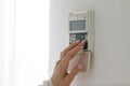 Female fingers set comfortable temperature at home use digital thermostat Royalty Free Stock Photo