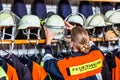 Female fire fighter in the locker room taking helmet Royalty Free Stock Photo