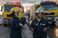 Female Fire and rescue firefighters combating a building fire