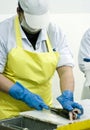 Female fish cutter at work Royalty Free Stock Photo