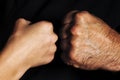 Female fist against male fist. Punch is a severe and agressive opposition. Opposite direction. The concept of confrontation and