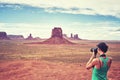 Female fit photographer takes pictures in Monument Valley, USA. Royalty Free Stock Photo