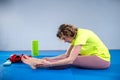 Female fitness athlete doing warm up workout. Stretching exercises at gym. Woman muscle stretching legs on mat in health club. Royalty Free Stock Photo