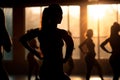 female fitness in the gym, silhouettes of women involved in sports with sundown background generative ai Royalty Free Stock Photo