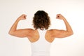 Female fitness instructor flexing arm muscles