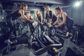 Female fitness instructor leading group of girls on cycling class in gym Royalty Free Stock Photo