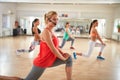 Female fitness instructor with microphone training group Royalty Free Stock Photo