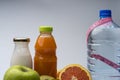 Female fitness still life. Healthy food, fruit, juice and water on grey background Royalty Free Stock Photo