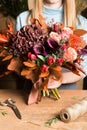 Female florist with bunch of autumn flowers Royalty Free Stock Photo