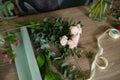 Female florist creating beautiful bouquet in flower shop, close up