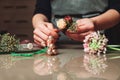 Female florist creating bouquet decoration closeup