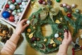 Female florist decorator making Christmas wreath Royalty Free Stock Photo