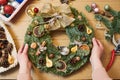 Female florist decorator making Christmas wreath Royalty Free Stock Photo