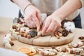 Female florist decorator making Christmas wreath Royalty Free Stock Photo