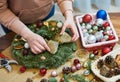 Female florist decorator making Christmas wreath Royalty Free Stock Photo