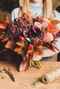 Female florist with bunch of autumn flowers Royalty Free Stock Photo