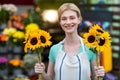 Female florist holding flowers in flower shop Royalty Free Stock Photo