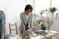 Female florist make floral decor compositions at home