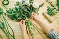 Florist ties a ribbon on a bouquet of flowers Royalty Free Stock Photo