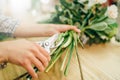 Florist ties a ribbon on a bouquet of flowers Royalty Free Stock Photo