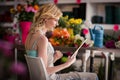 Female florist using digital tablet in florist shop Royalty Free Stock Photo