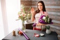 Female florist at work: pretty young dark-haired woman making fashion modern bouquet of different flowers. Women working Royalty Free Stock Photo