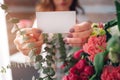 Female florist at work: pretty young dark-haired woman making fashion modern bouquet of different flowers. Women working Royalty Free Stock Photo