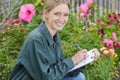 female florist writing on clipboard