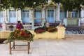 Female flower vendor waiting for customers in Thanboddhay temple complex courtyard