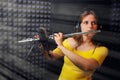 Female flute player plays in recording studio. Woman flutist in headphones playing the platinum flute. Record wind musical