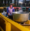 Female food vendor in yellow boat in Xochimilco lake