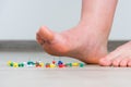 Female foot above colored pushpin Royalty Free Stock Photo