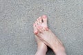 Female Foot Top View. Pink Nail Polish Manicure. Selfie of Woman Bare Feet On Road Background