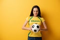 Female football fan holding ball on Royalty Free Stock Photo