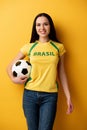 Female football fan holding ball on Royalty Free Stock Photo