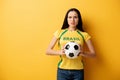 Female football fan holding ball on Royalty Free Stock Photo